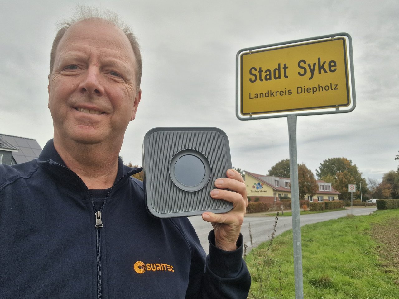 Michael Meyer mit dem Frühwarnsystem FRED am Ortsschild Syke